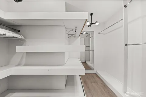 a bathroom with a granite countertop sink a mirror and a shower