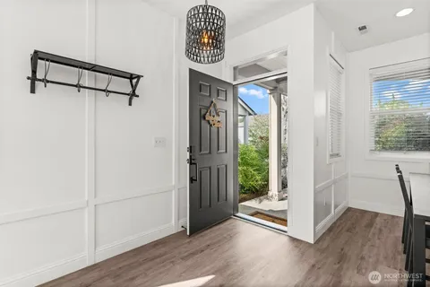 a living room with furniture and kitchen view