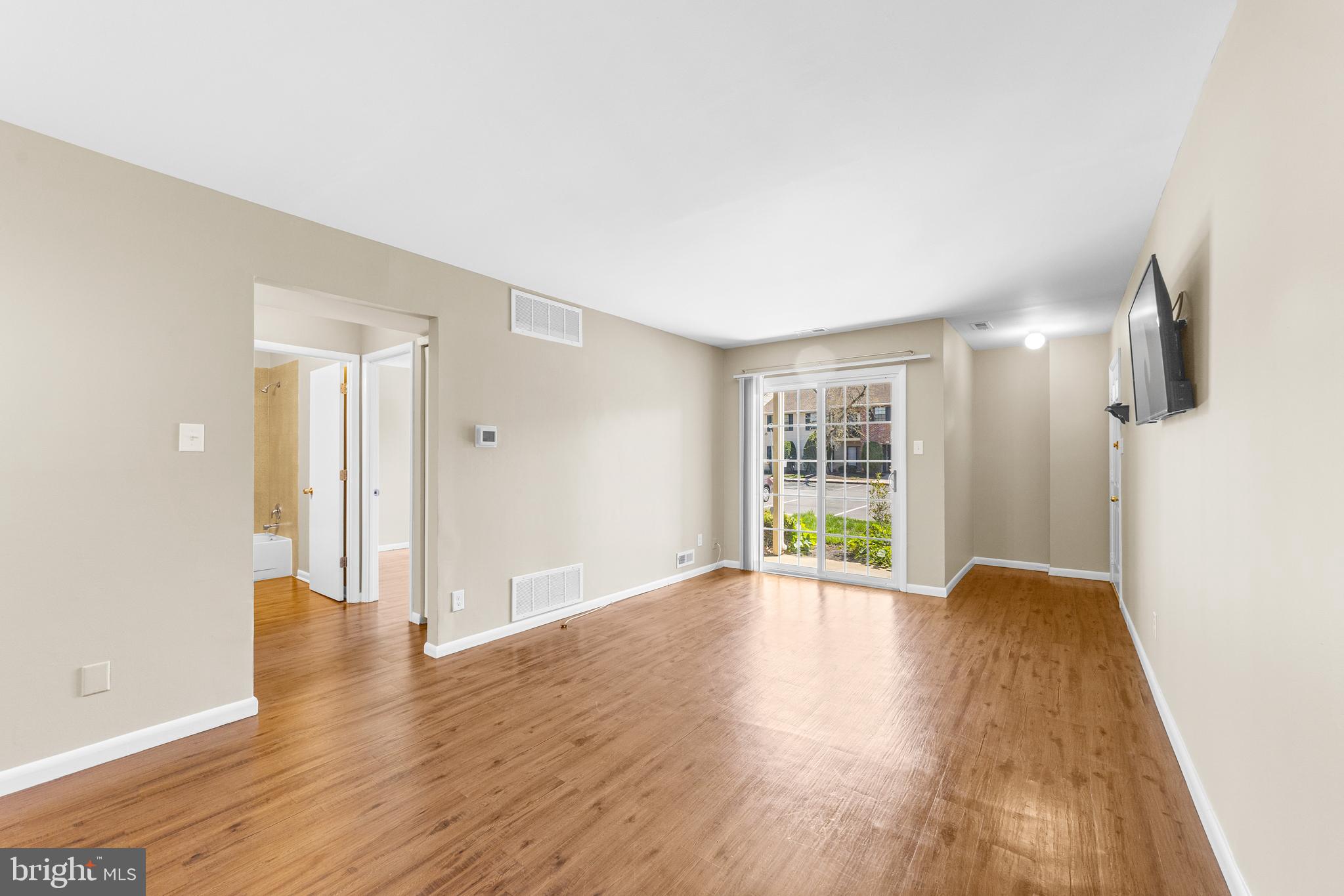 536 A Willow Turn Mount Laurel, NJ 08054 - Photo 11 of 20 a view of an empty room with wooden floor and a window