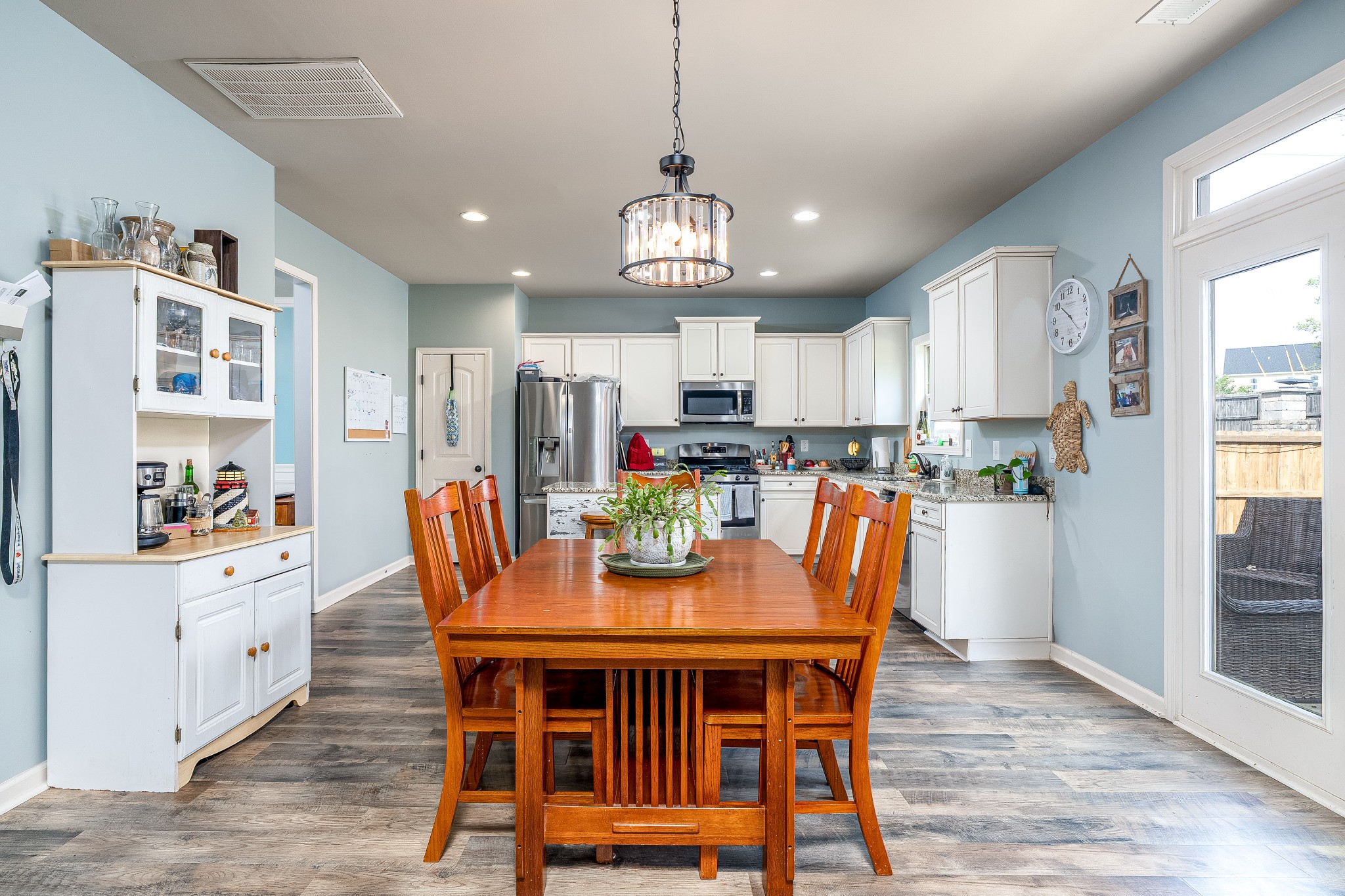 2034 Austin Drive Spring Hill, TN 37174 - Photo 13 of 41 a dining room with stainless steel appliances kitchen island granite countertop a dining table chairs and a refrigerator