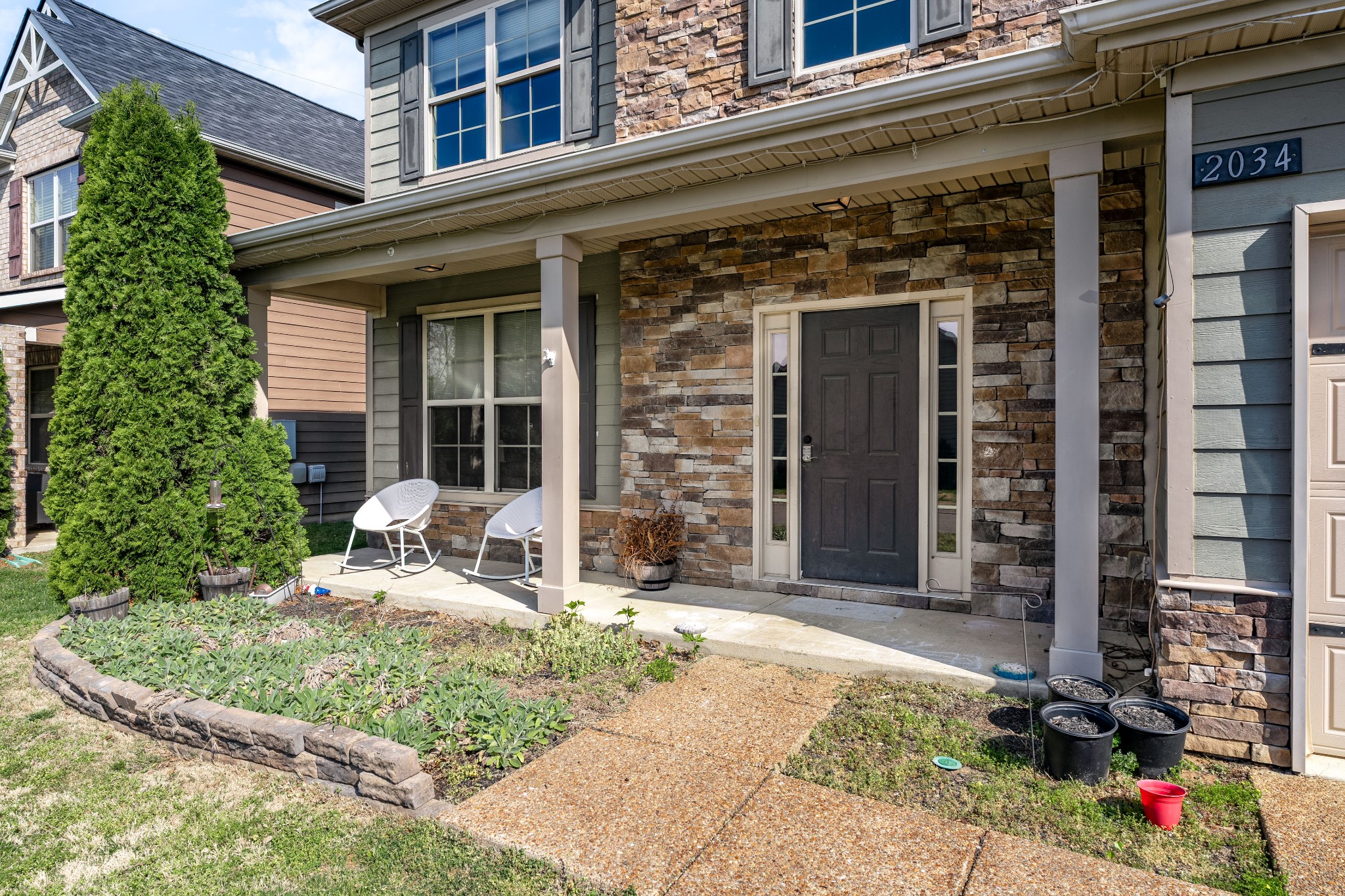 2034 Austin Drive Spring Hill, TN 37174 - Photo 4 of 41 a front view of a building with a garden and porch