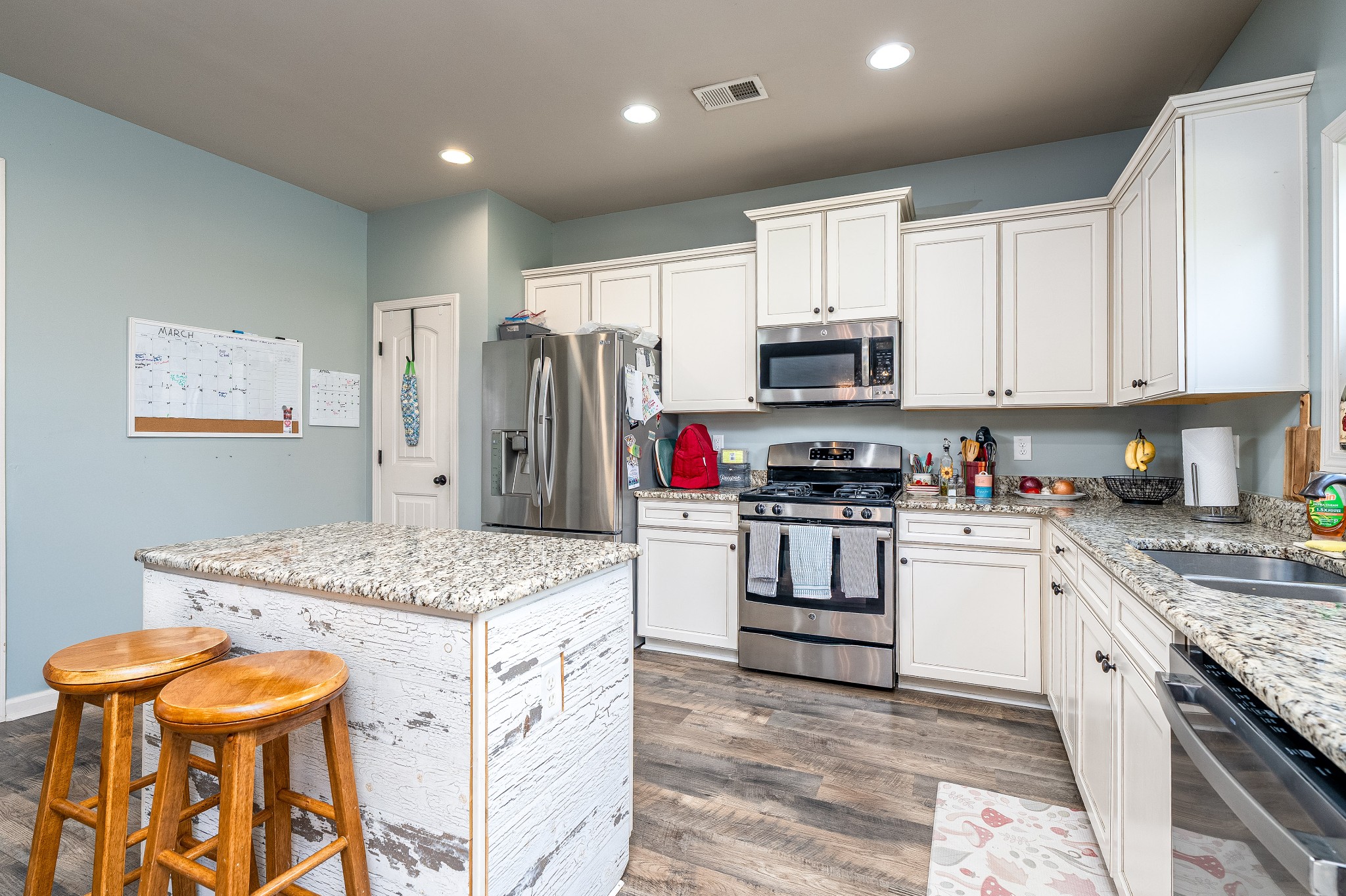 2034 Austin Drive Spring Hill, TN 37174 - Photo 8 of 41 a kitchen with granite countertop a stove top oven microwave and refrigerator
