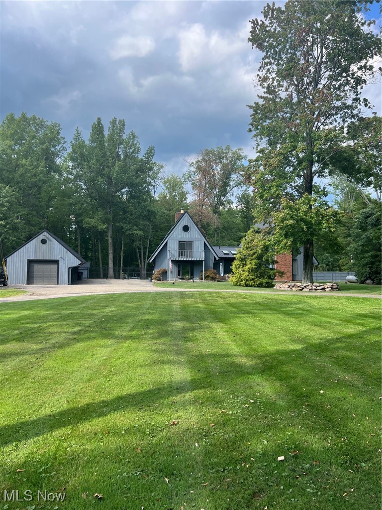 8731 Whipporwill Road Ravenna, OH 44266 - Photo 1 of 45 View of yard featuring a garage and an outdoor structure