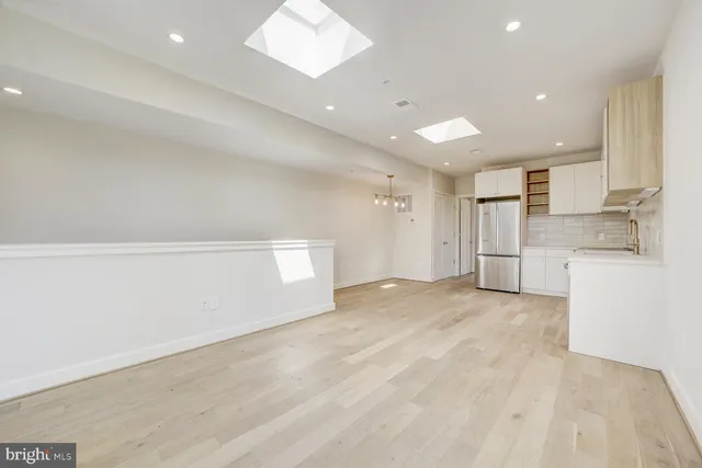 a view of a kitchen with white cabinets