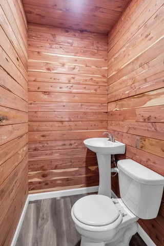 a bathroom with a toilet a sink and mirror