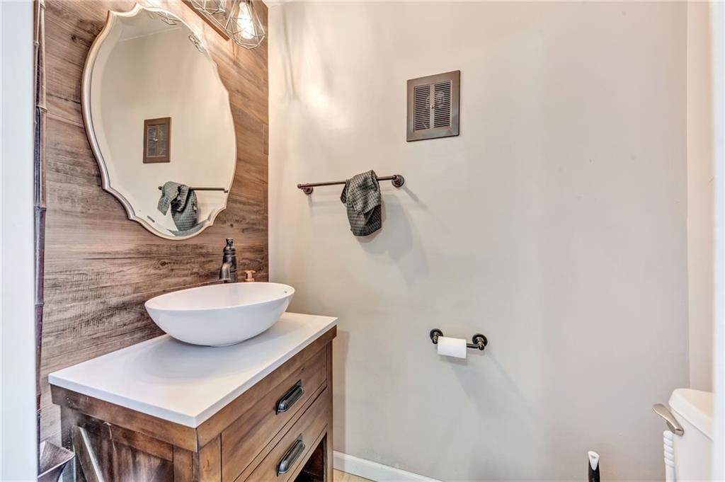 3941 Drexel Road Pittsburgh, PA 15212 - Photo 21 of 25 a bathroom with a sink a mirror and a toilet