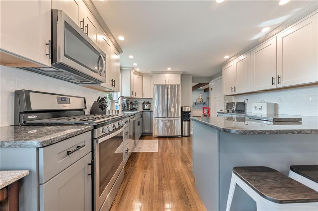 3941 Drexel Road Pittsburgh, PA 15212 - Photo 9 of 25 a kitchen with stainless steel appliances granite countertop a stove a sink and a refrigerator