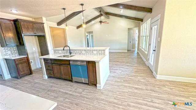 a spacious bathroom with a tub sink and a mirror