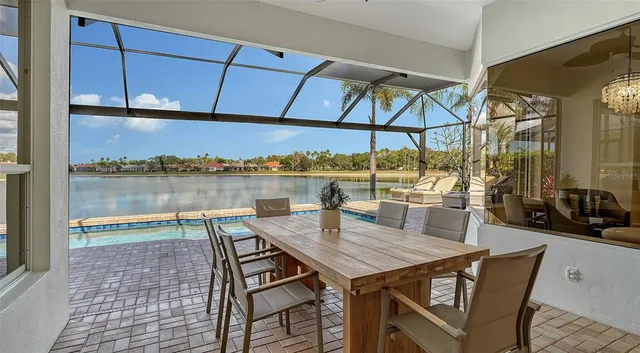a kitchen with stainless steel appliances granite countertop a sink a stove and a wooden floors