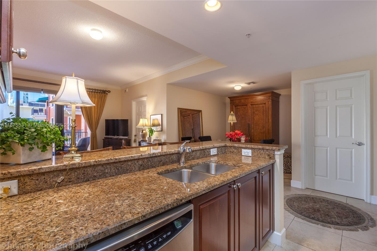 100 Andalusia Avenue, Unit 609 Coral Gables, FL 33134 - Photo 12 of 25 a kitchen with granite countertop a sink and a stove
