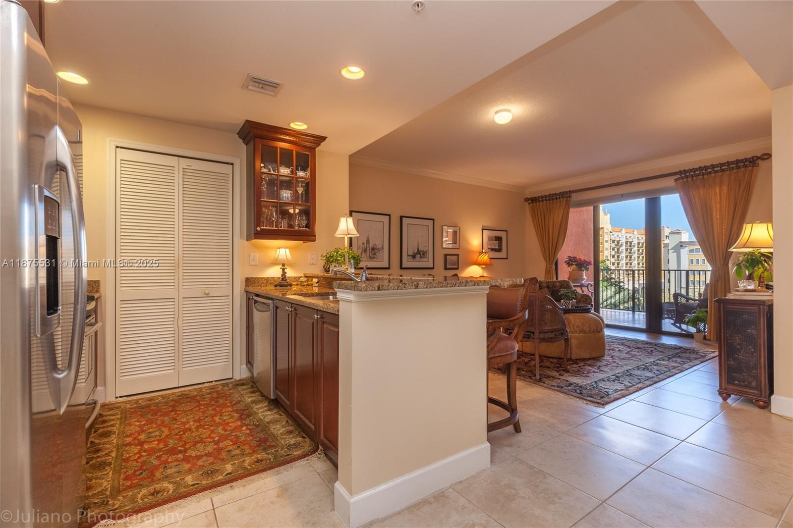 100 Andalusia Avenue, Unit 609 Coral Gables, FL 33134 - Photo 13 of 25 a kitchen with refrigerator and table