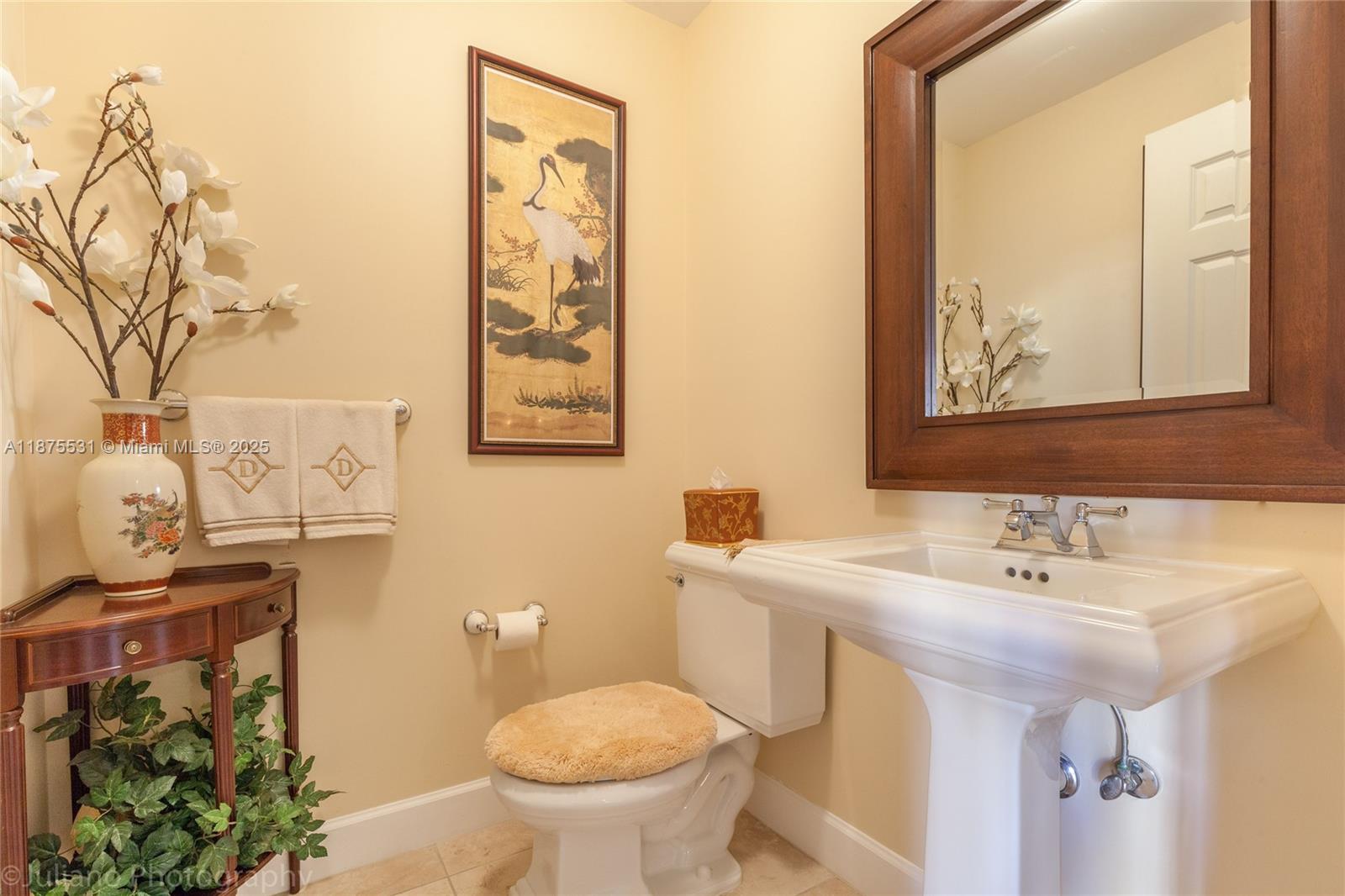 100 Andalusia Avenue, Unit 609 Coral Gables, FL 33134 - Photo 14 of 25 a bathroom with a sink and mirror with toilet