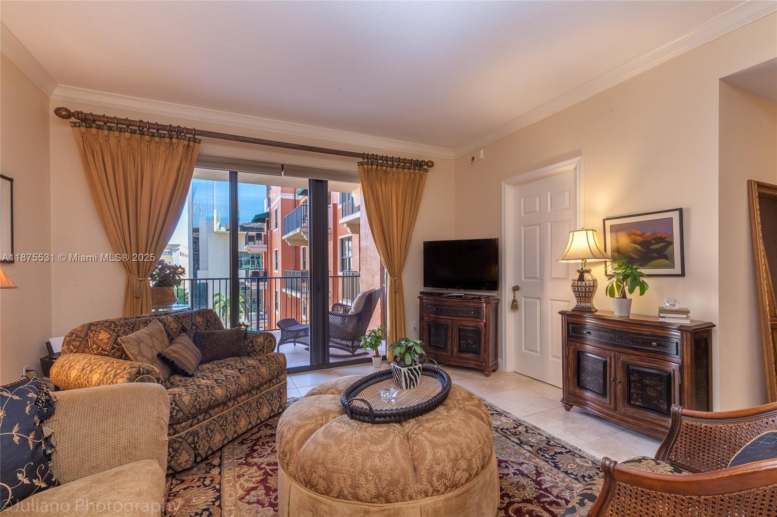 100 Andalusia Avenue, Unit 609 Coral Gables, FL 33134 - Photo 16 of 25 a living room with furniture and a flat screen tv