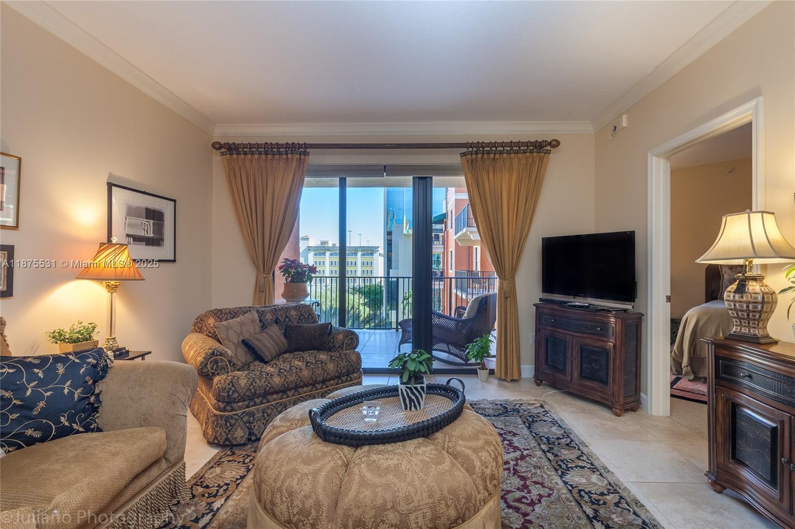 100 Andalusia Avenue, Unit 609 Coral Gables, FL 33134 - Photo 17 of 25 a living room with furniture and a flat screen tv