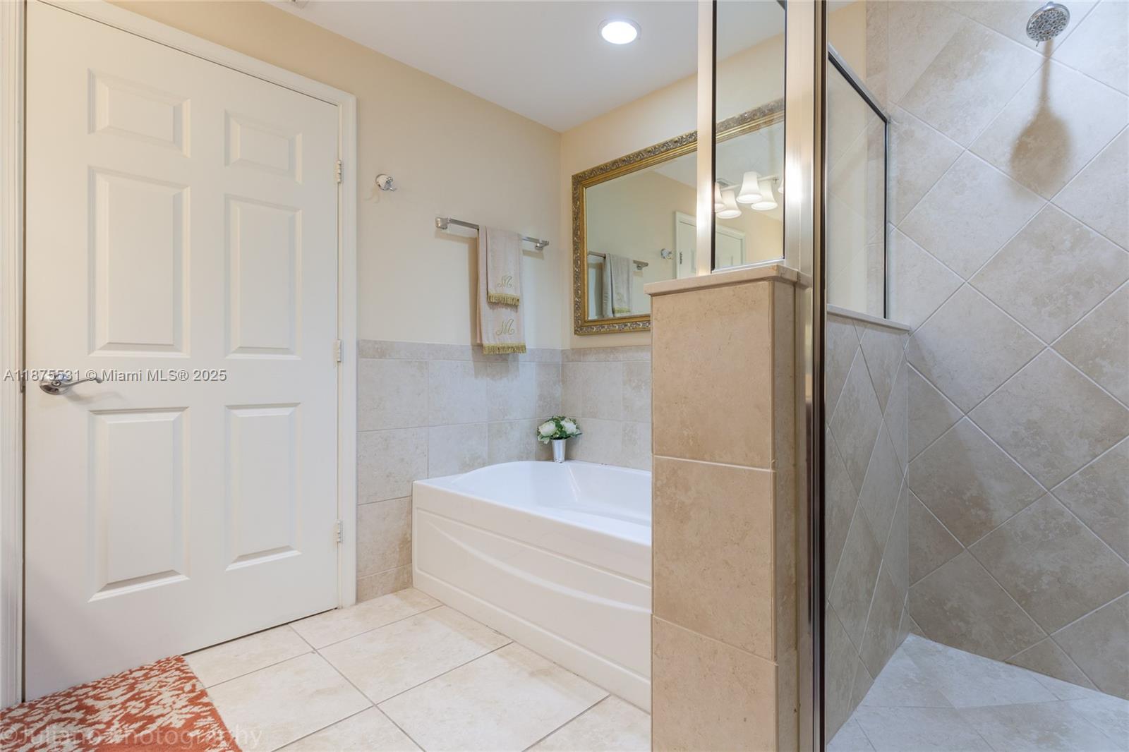 100 Andalusia Avenue, Unit 609 Coral Gables, FL 33134 - Photo 22 of 25 a bathroom with a bathtub and a shower