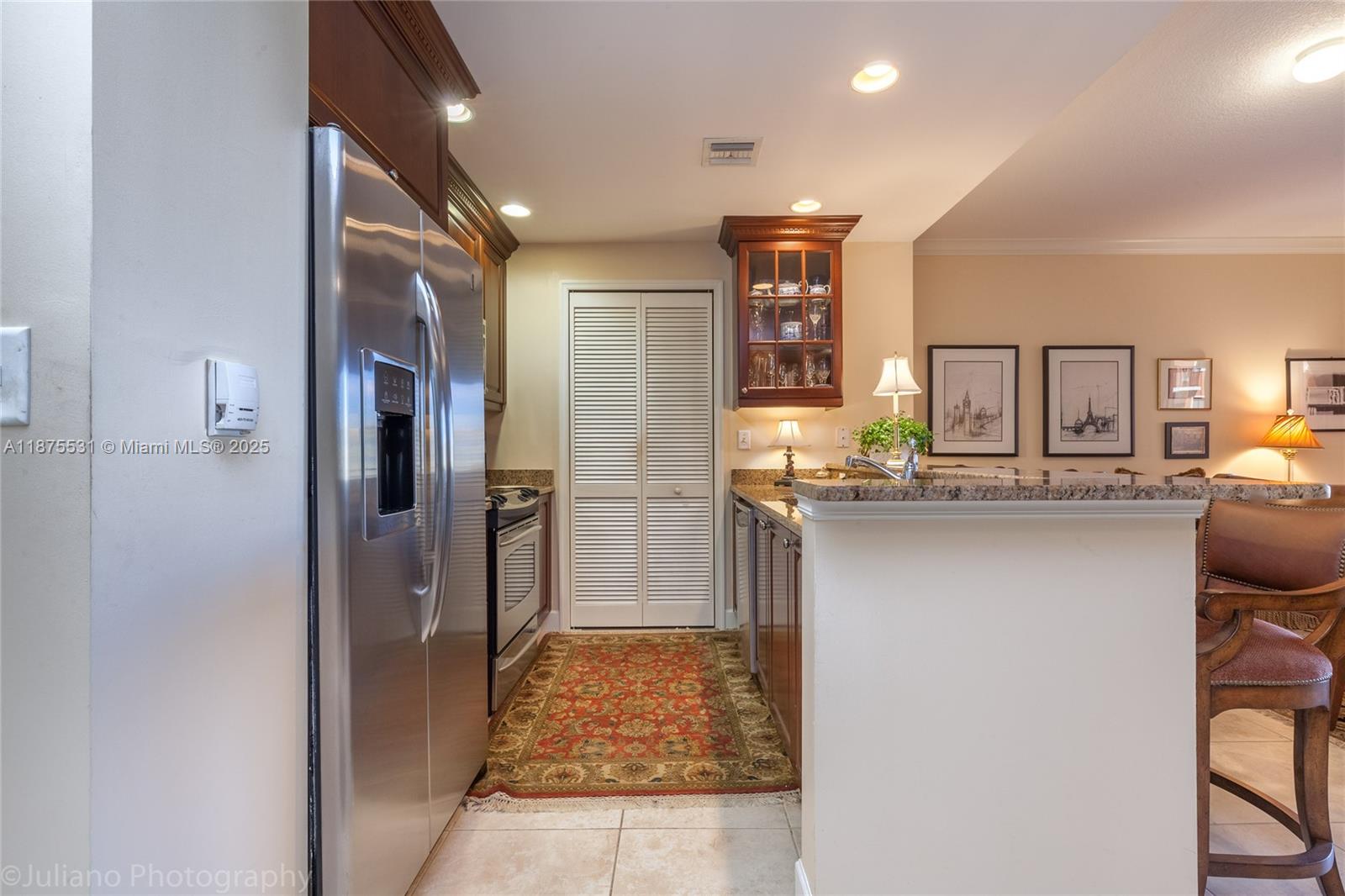 100 Andalusia Avenue, Unit 609 Coral Gables, FL 33134 - Photo 10 of 25 a kitchen with refrigerator and cabinets