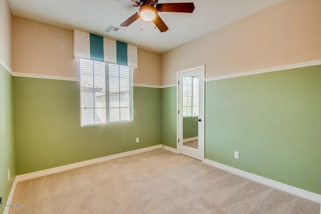 a spacious bathroom with a double vanity sink mirror and toilet