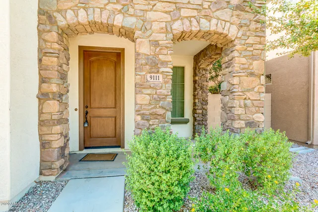 a view of an empty room with a window and a ceiling fan