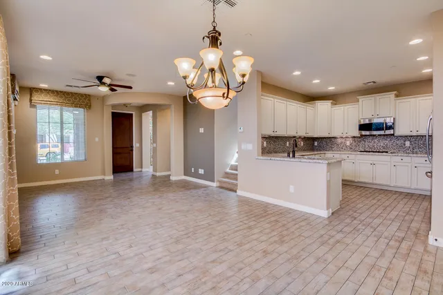 a kitchen with stainless steel appliances granite countertop a sink refrigerator and microwave
