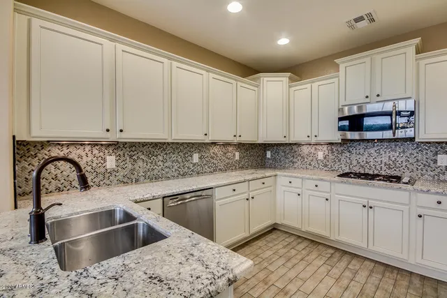a kitchen with a stove and a microwave