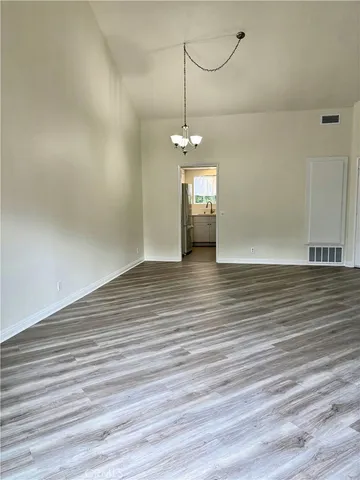 a view of a room with wooden floor and window