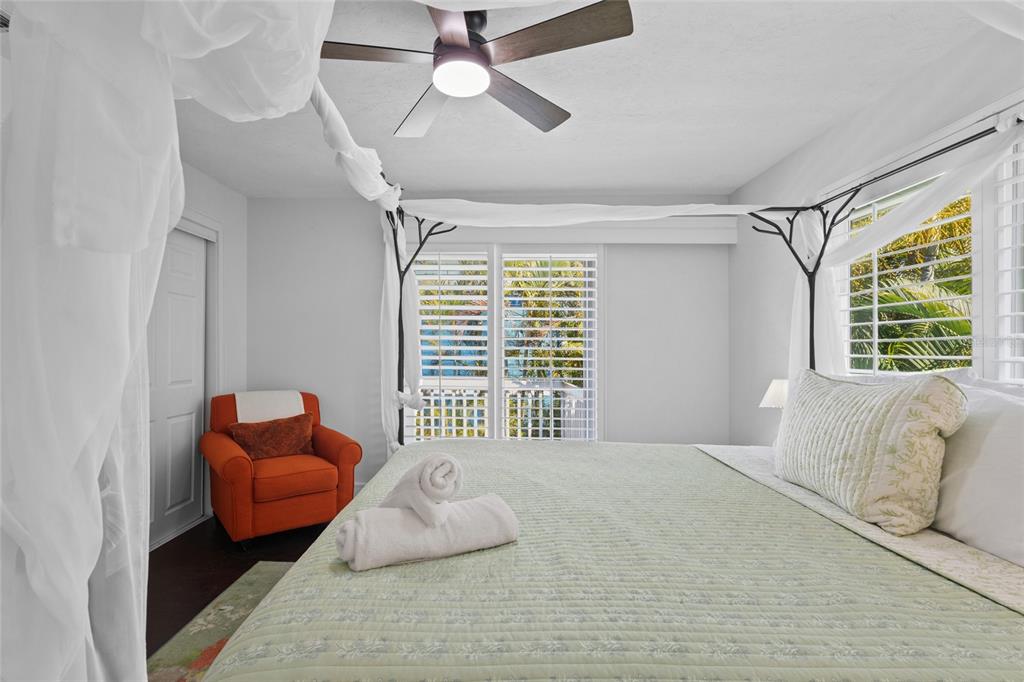 315 Spring Avenue Anna Maria, FL 34216 - Photo 32 of 63 a bedroom with furniture and a large window