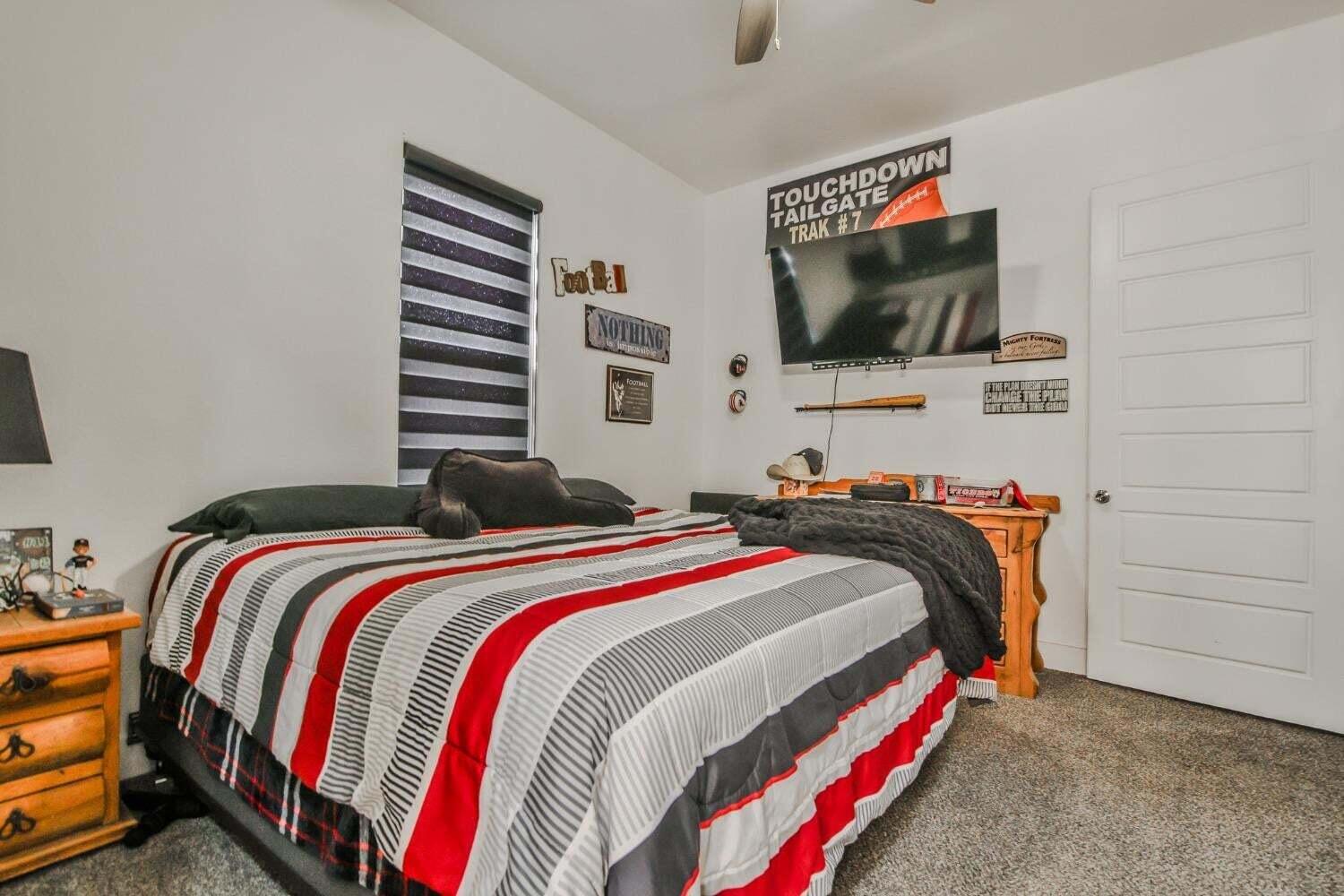 19210 County Road 2240 Lubbock, TX 79423 - Photo 23 of 46 a bedroom with a bed and a flat screen tv