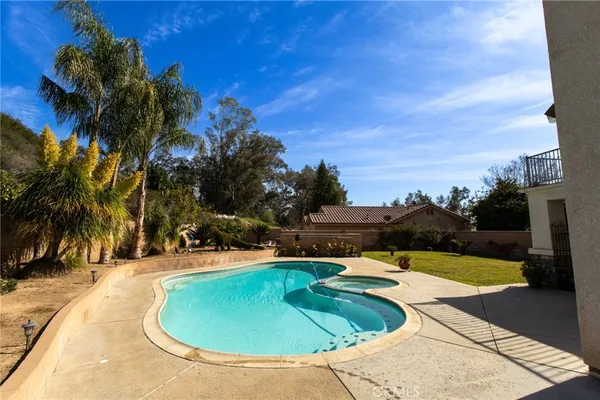 a view of a swimming pool with a yard
