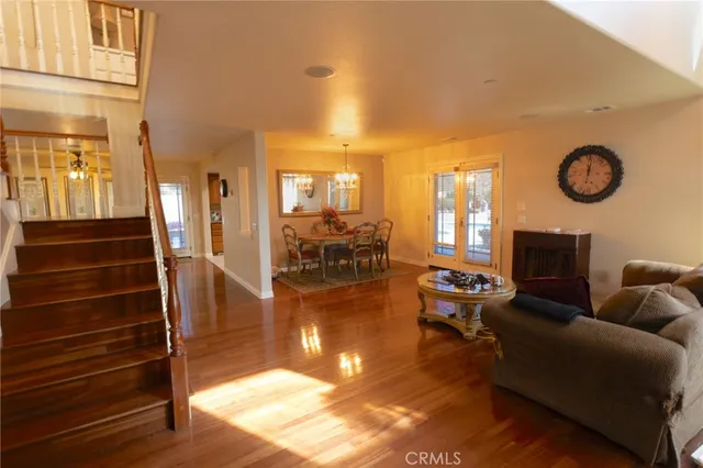 a living room with fireplace furniture and a large window