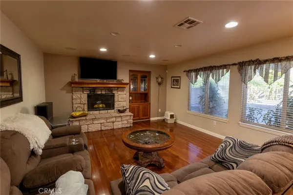 a living room with furniture a large window and a fireplace