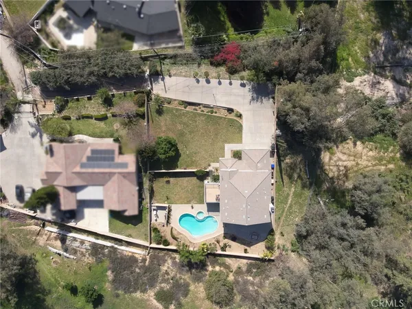 an aerial view of a house with a yard and lake view
