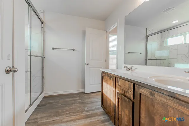 a bathroom with a double vanity sink and mirror