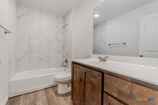 a bathroom with a sink a toilet and a bathtub