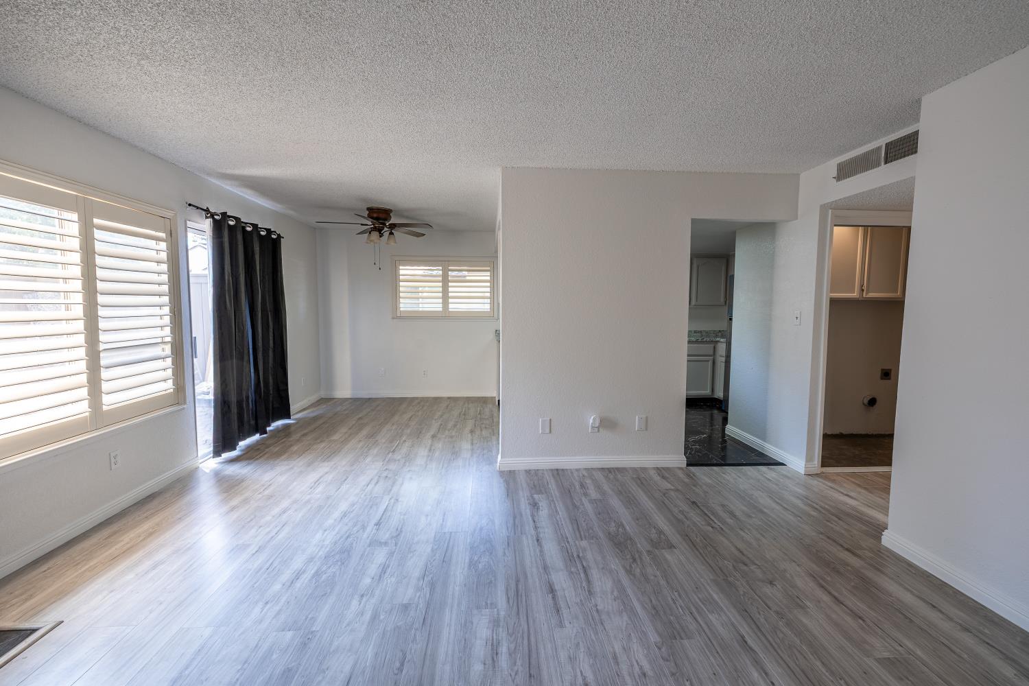 3700 Tully Road, Unit 5 Modesto, CA 95356 - Photo 6 of 38 an empty room with wooden floor and windows