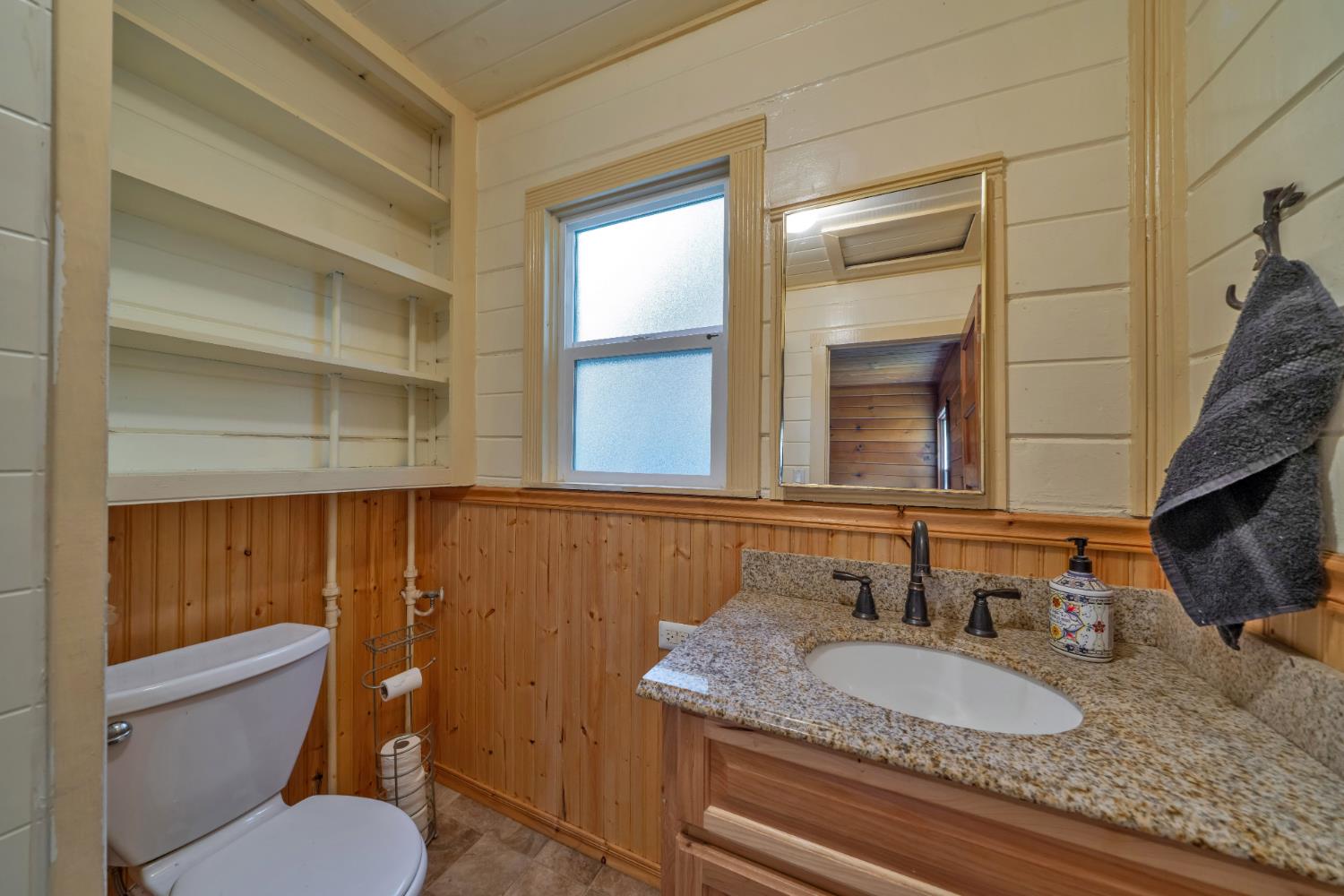 6929 Split Bend Road Pollock Pines, CA 95726 - Photo 20 of 38 a bathroom with a granite countertop toilet sink and mirror