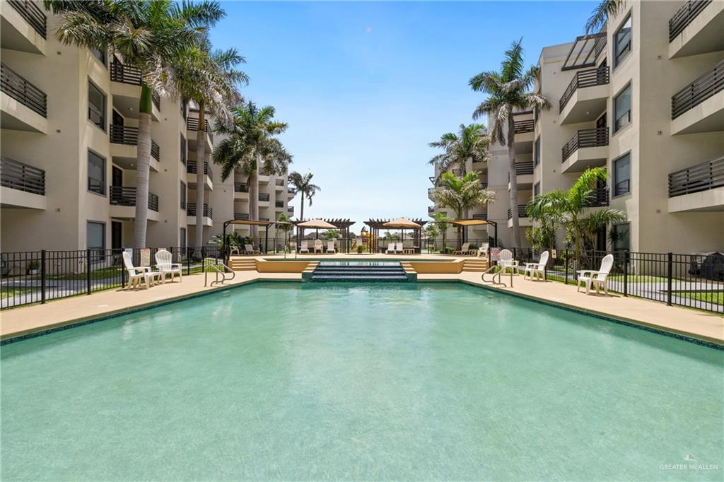 813 Travis Street, Unit 203 Mission, TX 78572 - Photo 26 of 30 a view of a lake with building and outdoor seating