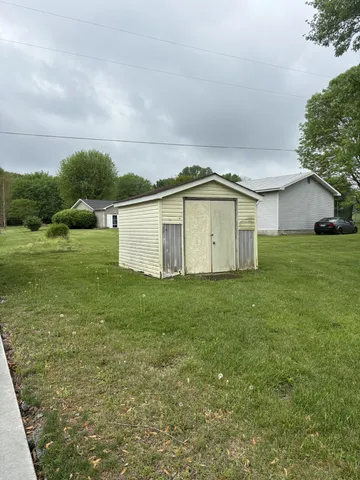 a backyard of a house with lots of green space and mountain view in back