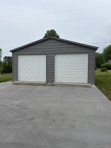 a view of garage and yard
