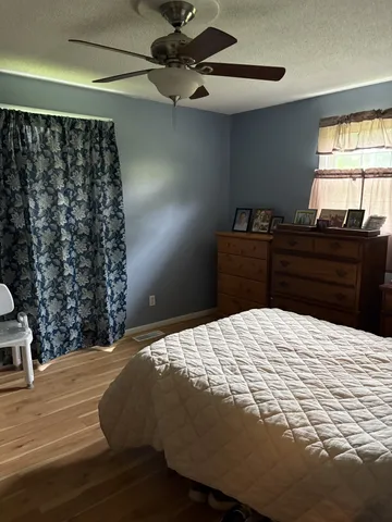 a bedroom with a bed and a window