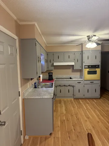 a kitchen with stainless steel appliances a sink and a refrigerator