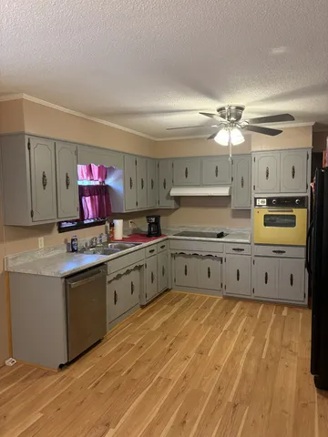 a kitchen with stainless steel appliances granite countertop a sink and cabinets