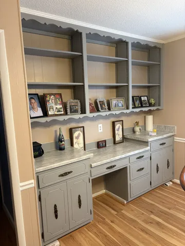 a kitchen with white cabinets and white appliances