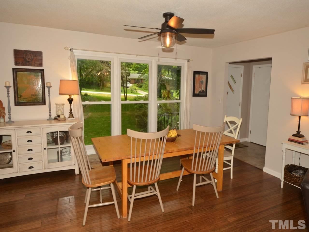 1228 Kingston Ridge Road Cary, NC 27511 - Photo 3 of 19 a view of a dining room with furniture window and wooden floor