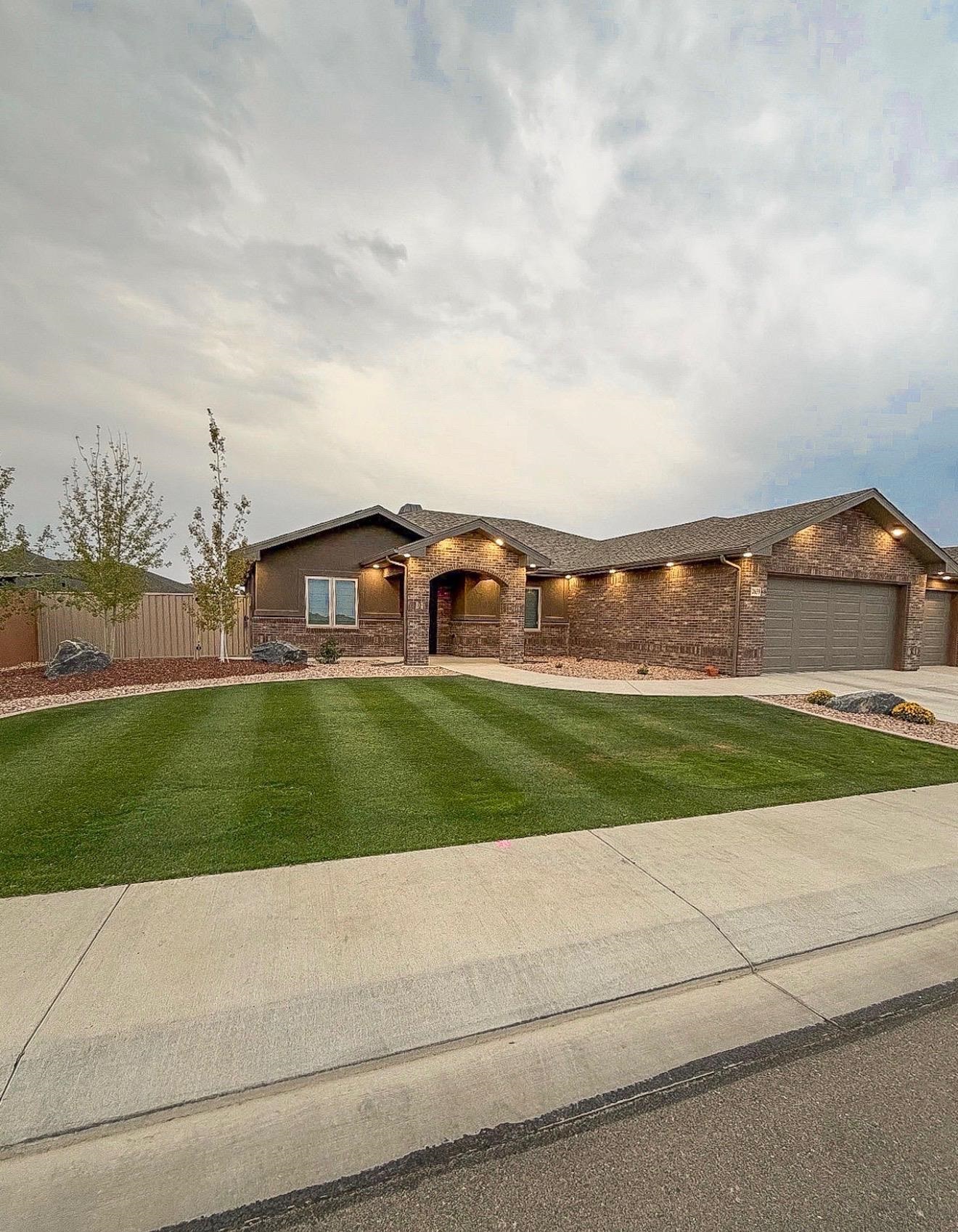 2639 Emerald Ridge Lane Grand Junction, CO 81506 - Photo 2 of 39 a view of a big house with a big yard and large trees