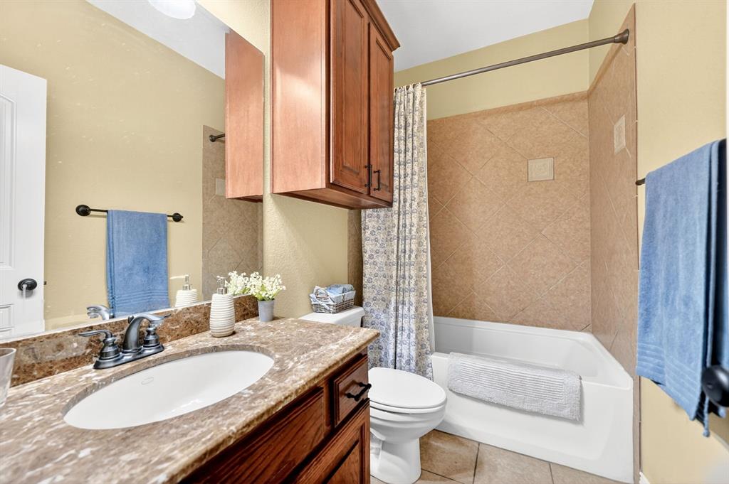 1399 Canyon Lake Road Wills Point, TX 75169 - Photo 21 of 37 a bathroom with a granite countertop sink toilet and shower