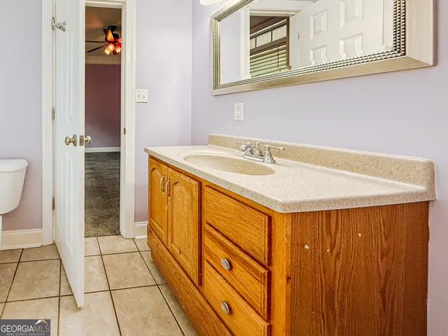 a bathroom with a toilet sink and mirror