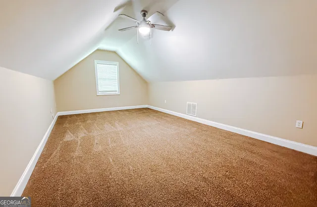 a view of an empty room and wooden floor