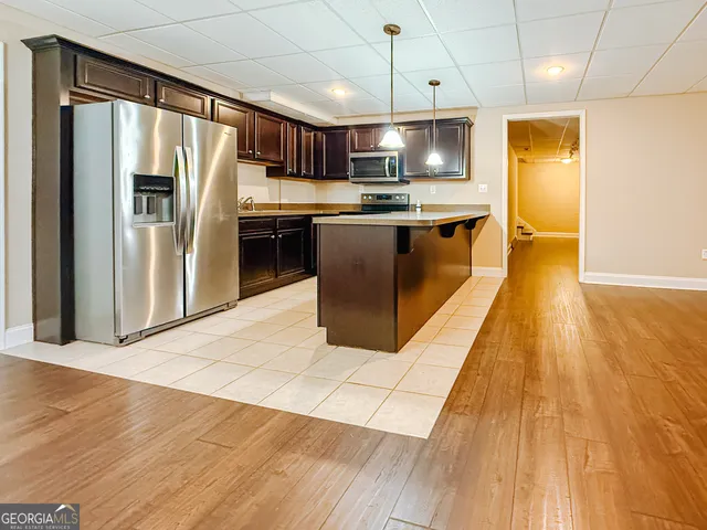 a view of a kitchen with a sink and wooden floor