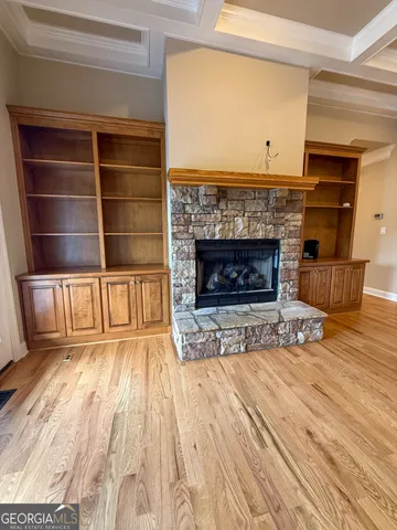 a view of a livingroom with a fireplace and window