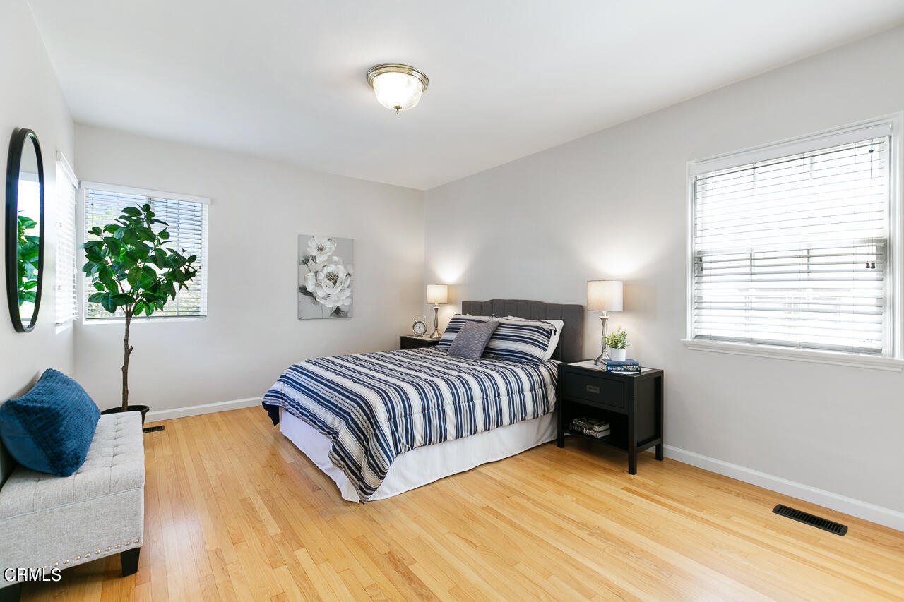 982 Athens Street Altadena, CA 91001 - Photo 13 of 25 a bedroom with a bed and a potted plant